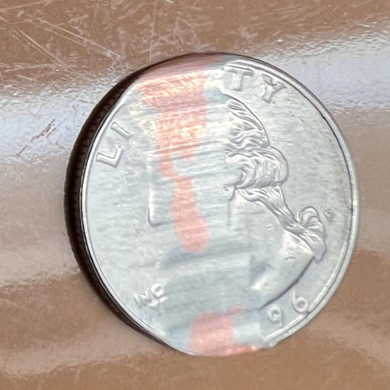 A quarter got trapped in the brushes by Roomba and polished part way ...