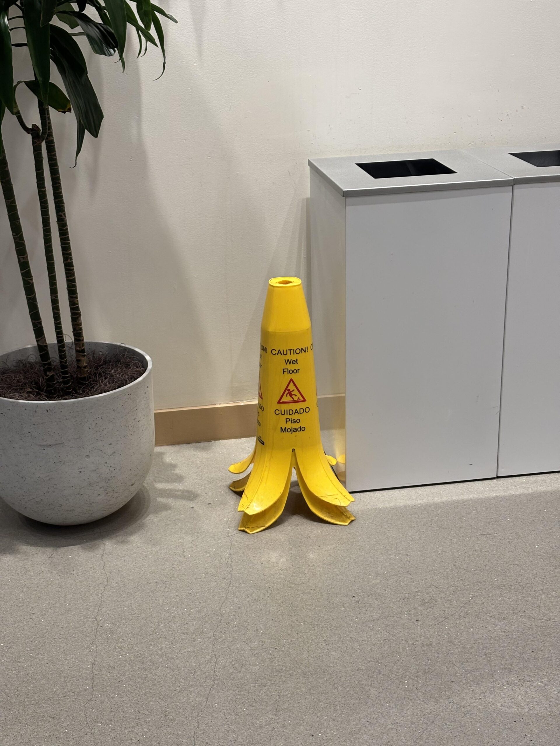 The wet floor signs in this café are shaped like banana peels. - USLUCK